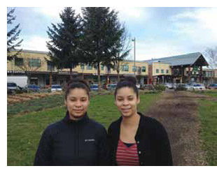 Cherise and Dennise Mofidi stand outside the Portland, Oregon restaurant where they were sexually harassed.
