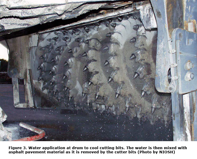 Figure 3. Water application at drum to cool cutting bits. The water is then mixed with asphalt pavement material as it is removed by the cutter bits (Photo by NIOSH)