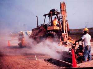 photo of worker working around clouds of dust