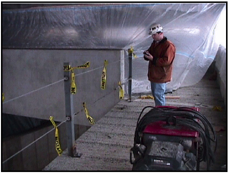 A WVU Fall-Safe coordinator audits a guard rail at a Fall-Safe contractor's site. 