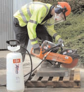  photo of a handheld power saw with dust suppression in use