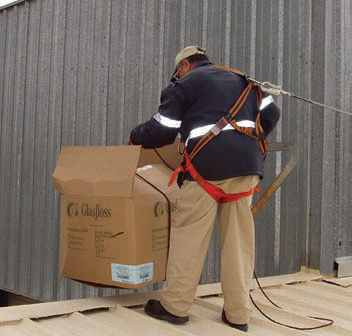 image of a worker with fall protection near a roof edge