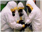 photo of Level C PPE with tyvek splash suit and APR respirators
