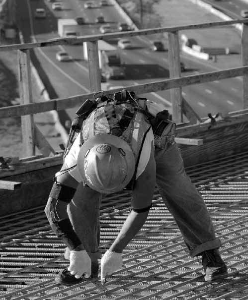 Figure 1. Rebar tying using pliers. Note the bent posture