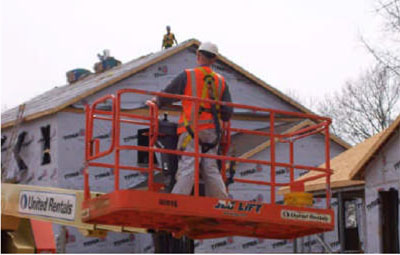 Figure 31 - Worker positioning an aerial lift.