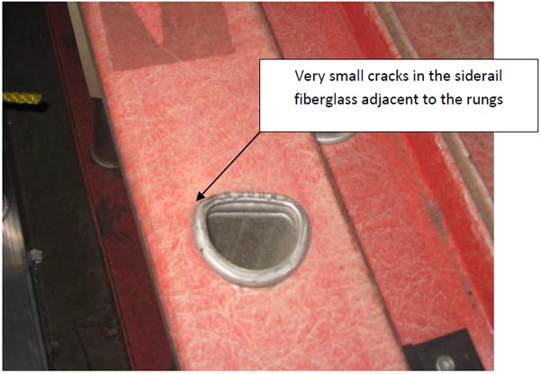 close up showing cracks in the siderail fiberglass adjacent to the rungs