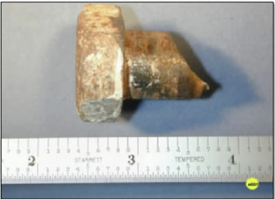 Profile view of embedded hex head bolt fragment