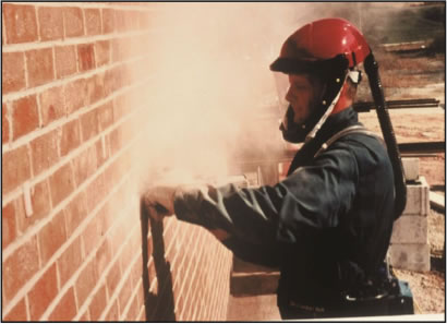 Worker using a grinder without dust controls