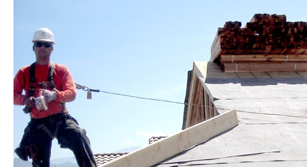 Man on a roof with safety tether