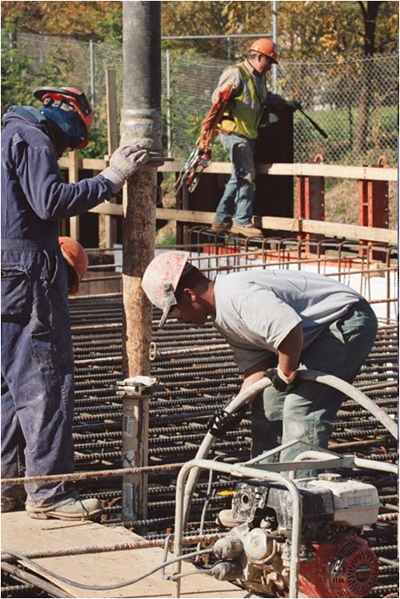 Photo of multiple workmen on rebar