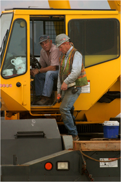 Photo of worker and manager on a machine