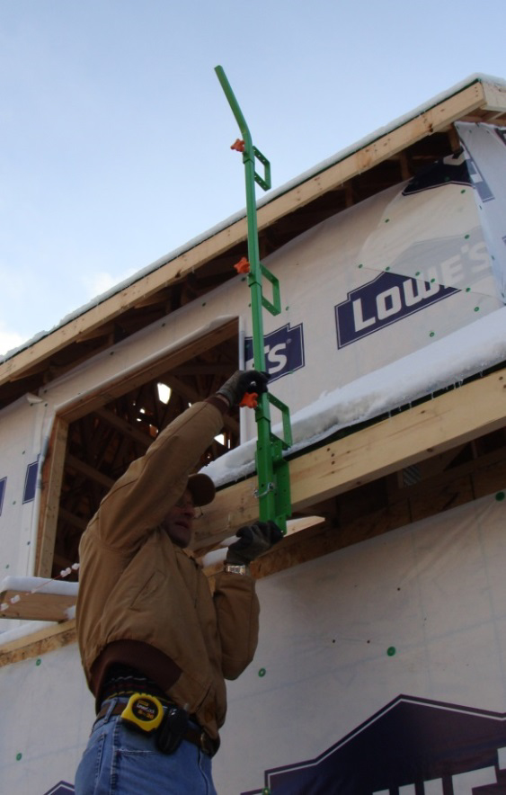 Figure 14. NIOSH researcher showing
use of offset base on fascia board. This
set-up would be installed only once and
left in place during all roofing activities.