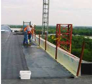workment installing a parapet wall on a bridge
