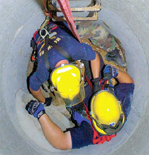 This is a picture of Emergency service workers performing a practice rescue inside a manhole photo from Oregon OSHA