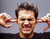 man with fingers in his ears