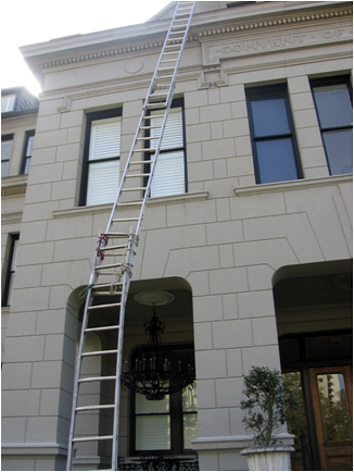 ladder tied to another ladder to make it look longer but losing integrity off the side of a building