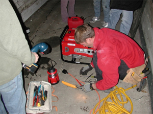 man working on wires in the dark